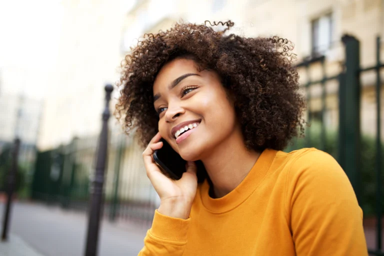 Happy woman on the phone outside